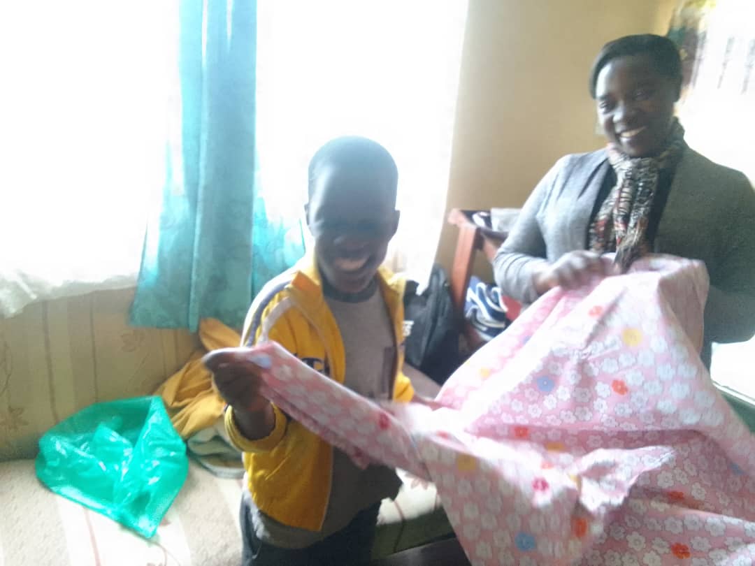 Mother giving blanket to child